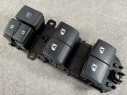 Black automotive power window switch panel with five rocker switches on a mounting frame, each labeled with an A icon.