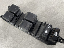 Power window switch panel from a car door with four individual window controls and a window-lock switch on the right side