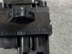 Close-up of a black plastic LEGO-like assembly with a curved clip and embossed code 4417SN on the side.