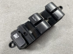 Car power window switch panel with auto window buttons on a black plastic base.