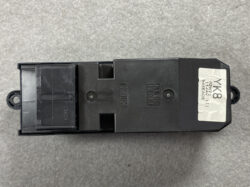 Black rectangular automotive electronic module with a tethered connector at left and a silver label reading 'K8' on the right side.