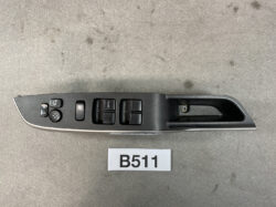 Driver-side car door panel with power window controls (four buttons, one labeled AUTO), mirror adjustment joystick, lock button, and a recessed door pull handle. SUZUKI SOLIO MITSUBISHI DELICA D2 Master Power Window Switch 37990-81P00 » JDM-PARTS NZ