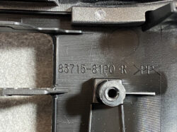 Close-up of a black plastic automotive mounting bracket showing the part number 83715-81P0 R and PP material mark with a circular boss and screw hole nearby.