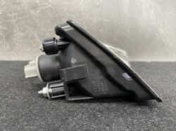 Automotive light assembly (black plastic) with a clear lens, mounting tabs, and wiring connector; appears to be an aftermarket Subaru/Mitsuba part for a 12V system