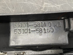 Close-up of a gray plastic component with embossed numbers: 53101-58140 A1 and 53101-581150.