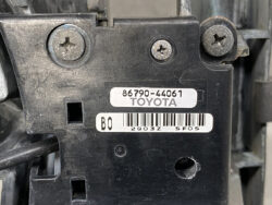 Close-up of a black automotive control module with two screws and a white label reading 86790-44061 TOYOTA and a barcode.