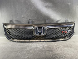 Front grille of a Honda car with chrome emblem and RSZ badge on the right side.