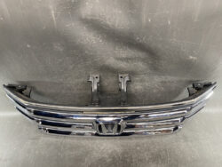 Chrome Honda front grille with central H emblem and mounting brackets visible for installation/exposure to the vehicle’s front end