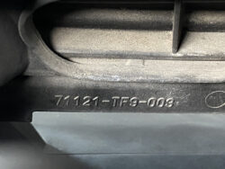 Close-up of a dusty car part with the stamped part number 71121-TF9-003.