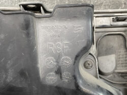Close-up of a Honda engine cover with 'R8F' part code and date stamps