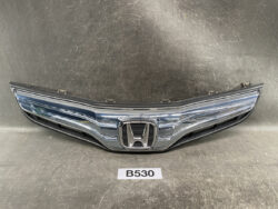 Front view of a chrome Honda car grille with emblem and black lower vents, part of a vehicle front end.