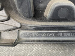 Close-up of a vehicle's front base grille with part number 71121-TF0-00 engraved in the plastic.