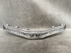 Front bumper lower grille piece, gray plastic, likely from the center of a car's bumper assembly.