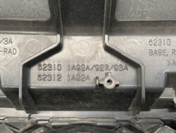 Close-up of a black plastic case latch area with embossed part numbers (62310, 62312) and a small circular knob/adjustment piece in the center wise.