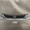 Front view of a blue Nissan car grille with a black honeycomb insert and emblem in the center, mounted on a matching bumper piece. NISSAN CUBE Z11 Genuine Radiator Grille 62310-4V70A » JDM-PARTS NZ