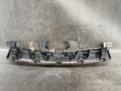 Long curved black plastic automotive interior trim piece with multiple clip tabs and mounting brackets