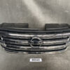 Front grille of a Nissan vehicle with chrome horizontal bars and circular Nissan emblem in the center NISSAN X-TRAIL T31 Genuine Radiator Grille 62310-JG00A » JDM-PARTS NZ