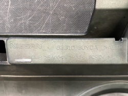 Close-up of a Nissan interior plastic label showing part number 62310 3V0A and material codes PA66, PA6, and ABS