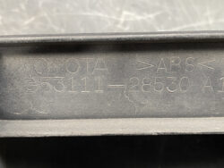 Close-up of a Toyota part with embossed text reading 'TOYOTA 53111-28530' and 'ABS' in a dusty black plastic housing, indicating a vehicle part label.