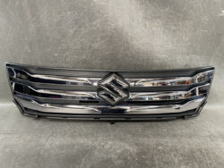 Front grille of a Suzuki vehicle with chrome bars and central emblem