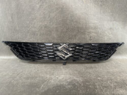Black honeycomb car grille with a chrome Suzuki emblem in the center.