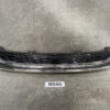 Front bumper grille assembly with a black honeycomb center and chrome trim, laid on a gray workshop surface. SUZUKI SOLIO MA36S MA46S Genuine Radiator Grille 71741-81P5 » JDM-PARTS NZ