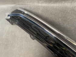 Black plastic car grille with a hexagonal honeycomb pattern and chrome edge trim.