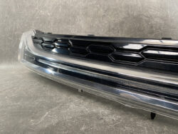 Close-up of a car's front grille with a black honeycomb pattern and chrome trim.