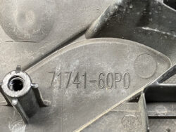 Close-up of a black plastic automotive part with the molded part number 71741-60P0 and a cylindrical threaded boss.