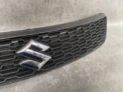 Front grille of a Suzuki vehicle with a chrome emblem in the center