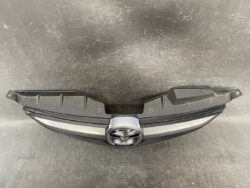 Front grille trim with Mazda logo in the center, from a car's front fascia.