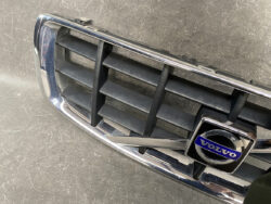 Volvo front grille with chrome trim and blue Volvo emblem on the badge