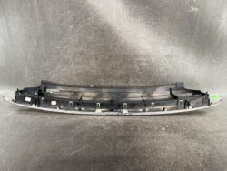 Black plastic car bumper cover with mounting clips, curved to fit a rear bumper