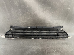 Front bumper grille assembly in black with horizontal slats and mounting tabs for a car.