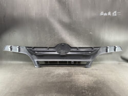 Front bumper cover for a car with lower grille, laid on a workshop floor