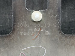 Close-up of a metal car part with stamped 'TOYOTA', 'ABS', and a bolt at the top center.