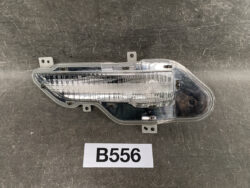 Clear automobile tail light/marker unit with multiple reflective strips and mounting tabs (part B556).