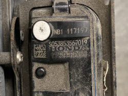 Close-up of a Honda identification plate on a dusty metal component, showing serial numbers and a QR code.