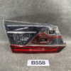 Tail light assembly with clear upper lens and red lower reflector on a grey surface. Two square reverse-light openings visible in the red section. TOYOTA ALPHARD VELLFIRE H20 Genuine Tailgate lens KOITO 58-38 Left Side x1 » JDM-PARTS NZ