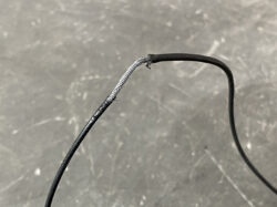 Suzuki Solio Mitsubishi Delica D:2 Genuine Power Slide Door Motor 79R0L Left Side 20 Close-up of a damaged electrical cable with exposed silver strands and frayed insulation.