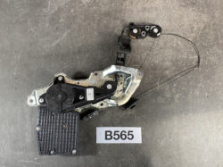 Car power window regulator with motor and cables on a dark background, labeled B565