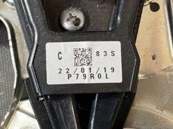 Suzuki Solio Mitsubishi Delica D:2 Genuine Power Slide Door Motor 79R0L Left Side 13 Close-up of a device mounting bracket with a white label showing a QR code, 'C 83 S', and a date like '22/01/19' on black plastic.