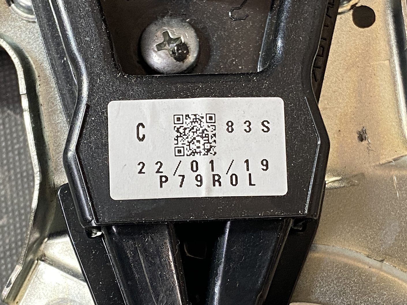 Suzuki Solio Mitsubishi Delica D:2 Genuine Power Slide Door Motor 79R0L Left Side 4 Close-up of a device mounting bracket with a white label showing a QR code, 'C 83 S', and a date like '22/01/19' on black plastic.